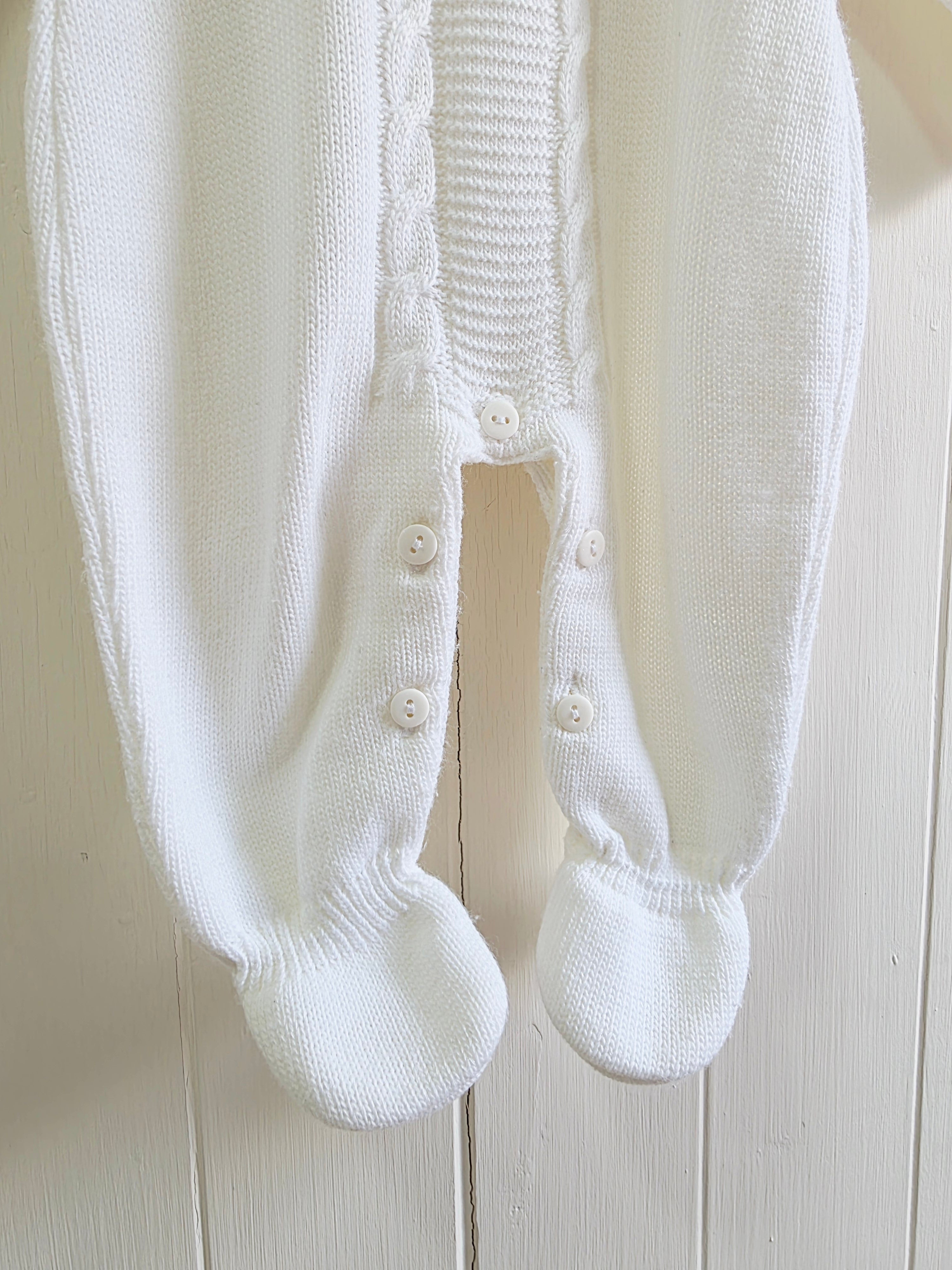 Dandelion - knitted baby romper in white featuring a traditional cable knit design Newborn