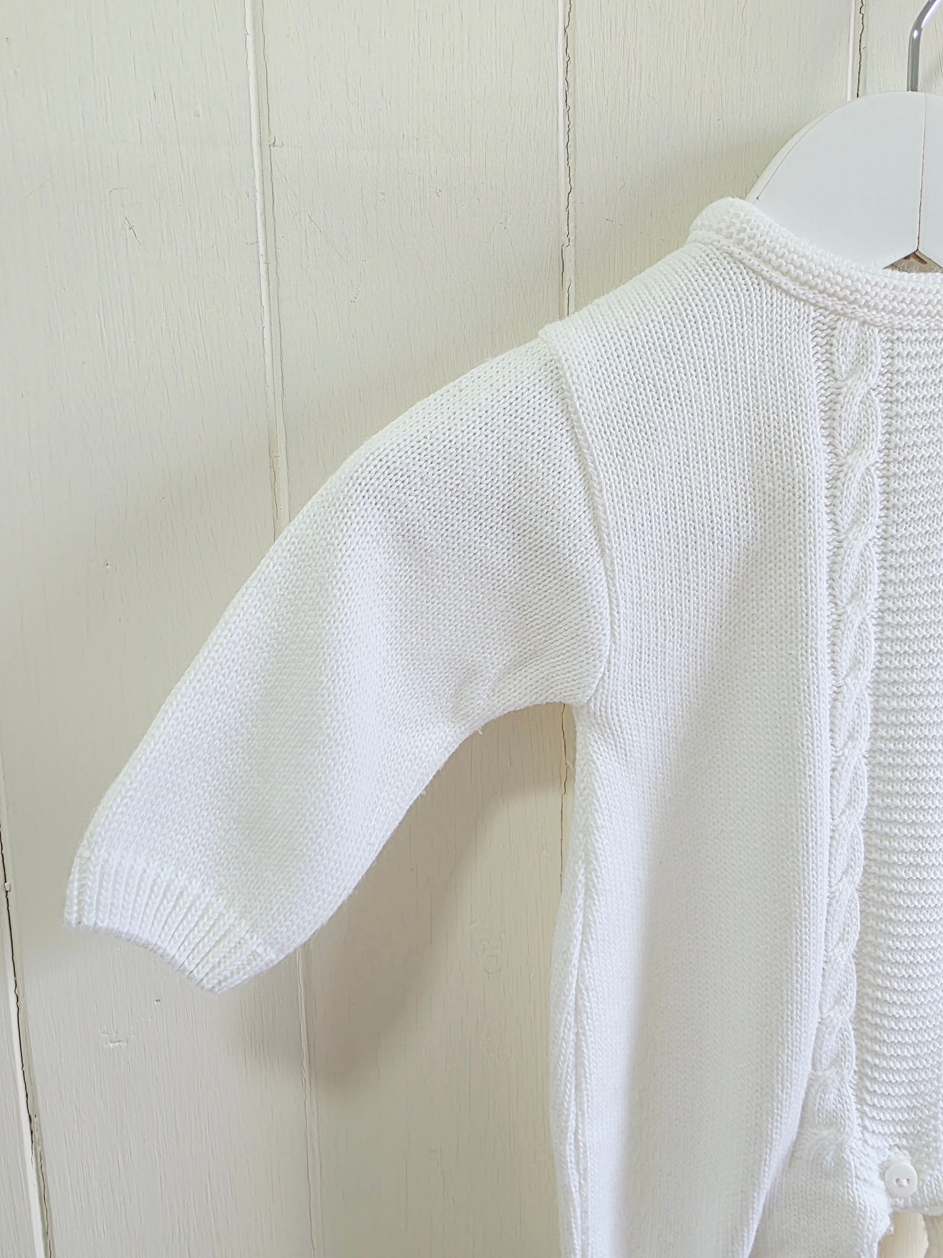 Dandelion - knitted baby romper in white featuring a traditional cable knit design Newborn