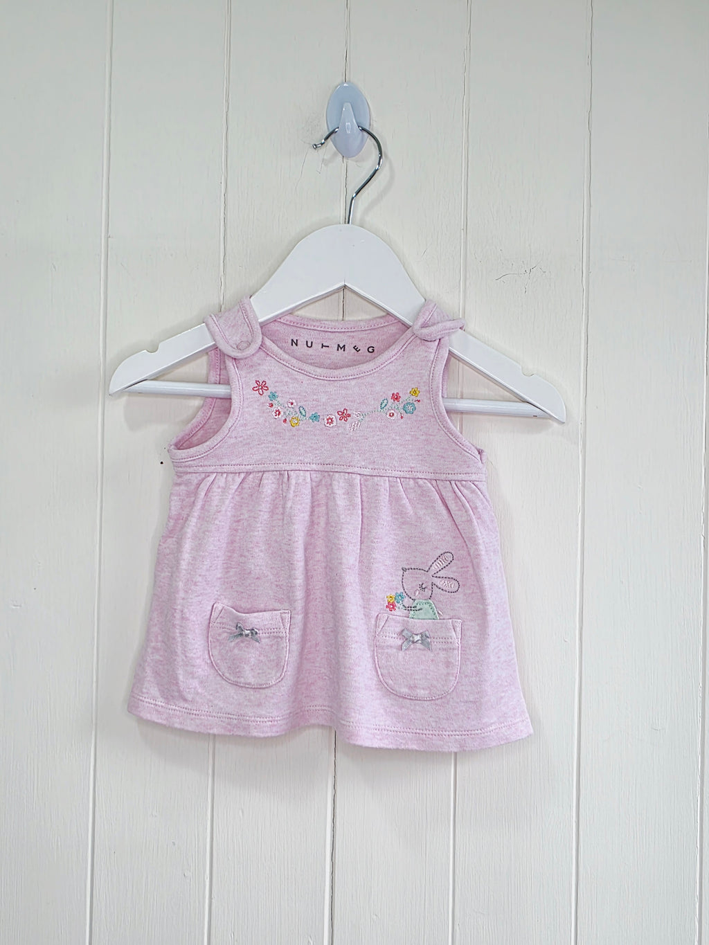 Nutmeg - newborn pink pinafore dress featuring floral embroidery and a bunny graphic