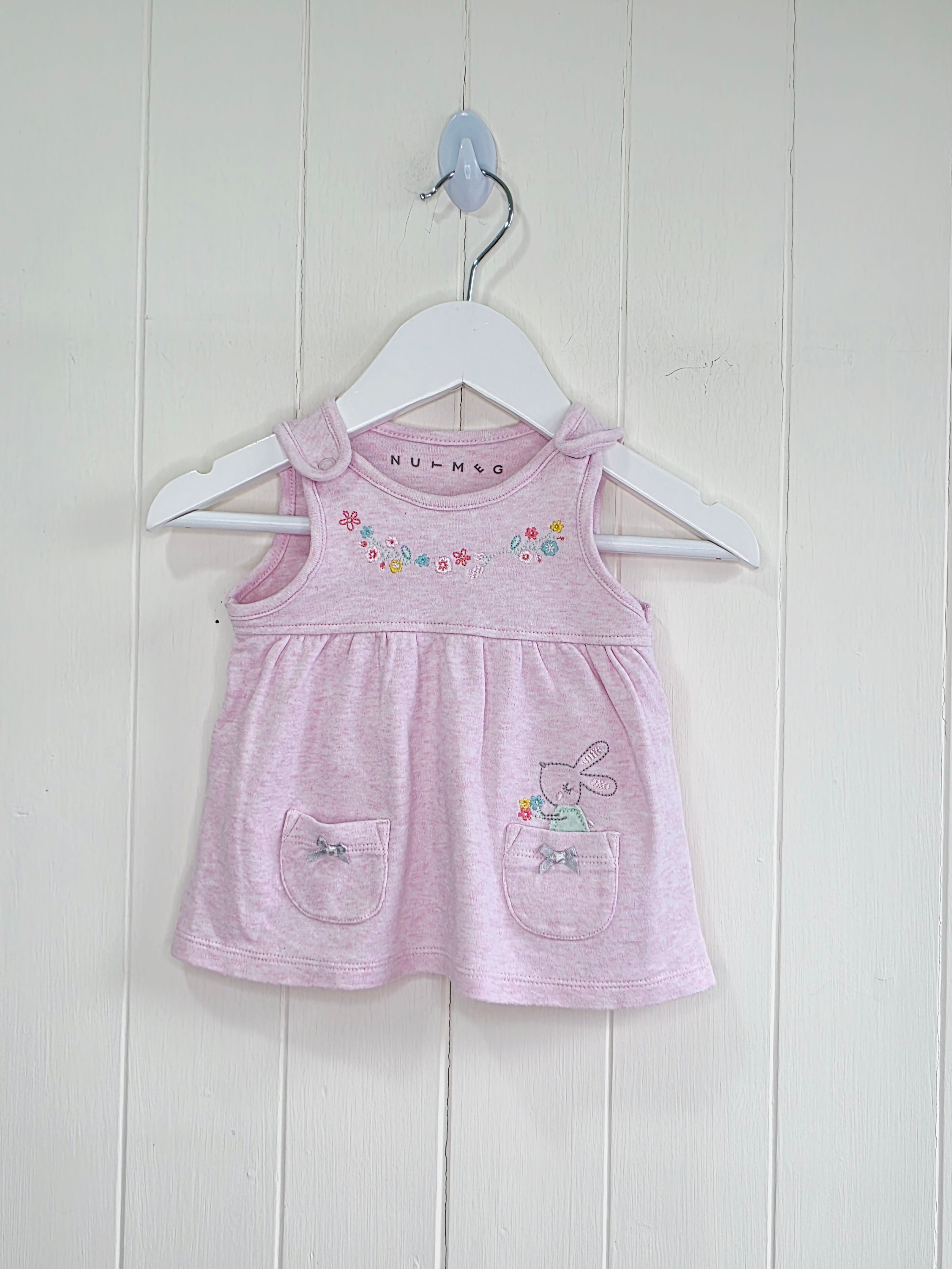 Nutmeg - newborn pink pinafore dress featuring floral embroidery and a bunny graphic