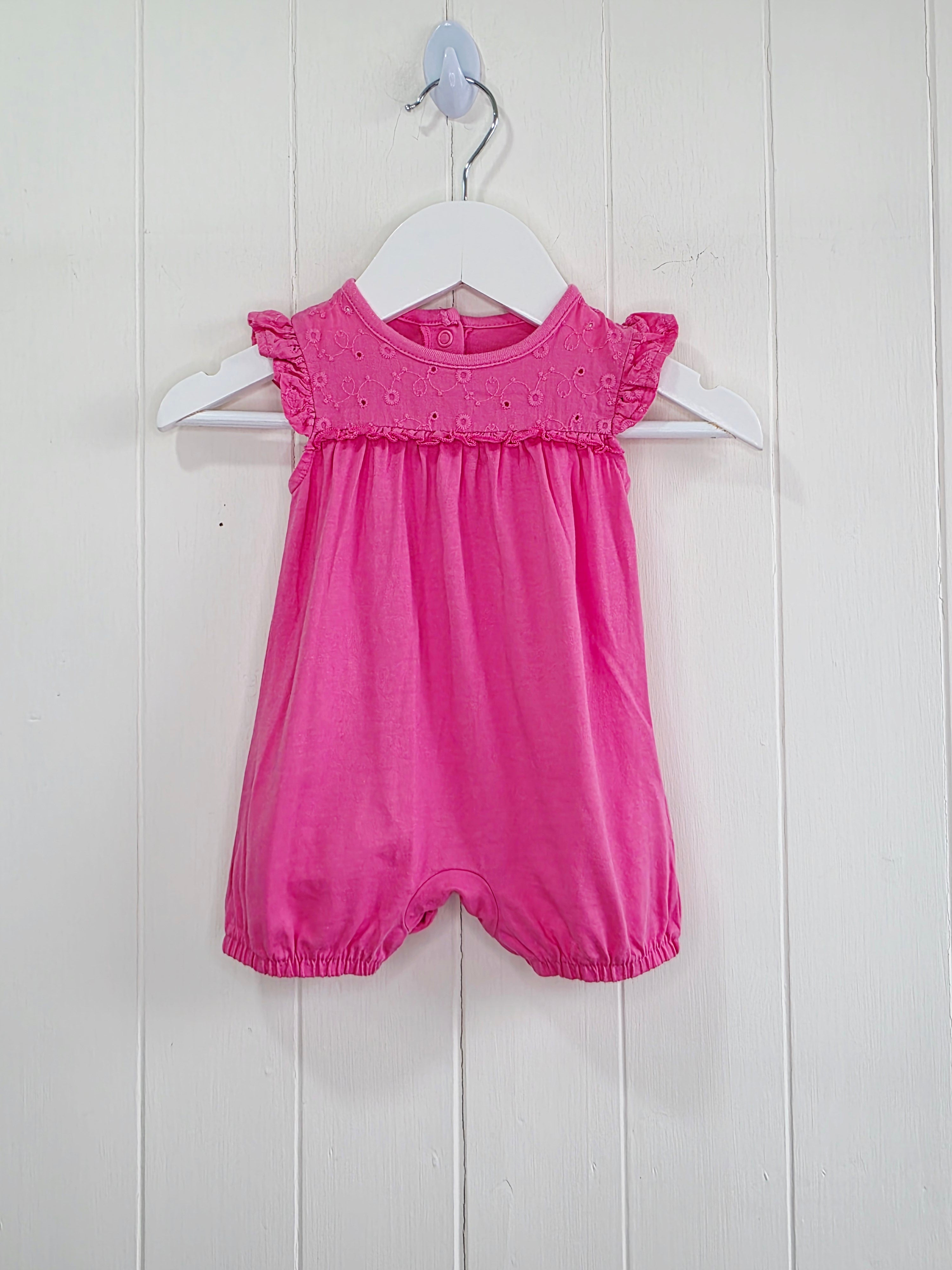 Nutmeg - newborn girls romper featuring broiderie anglaise detailing