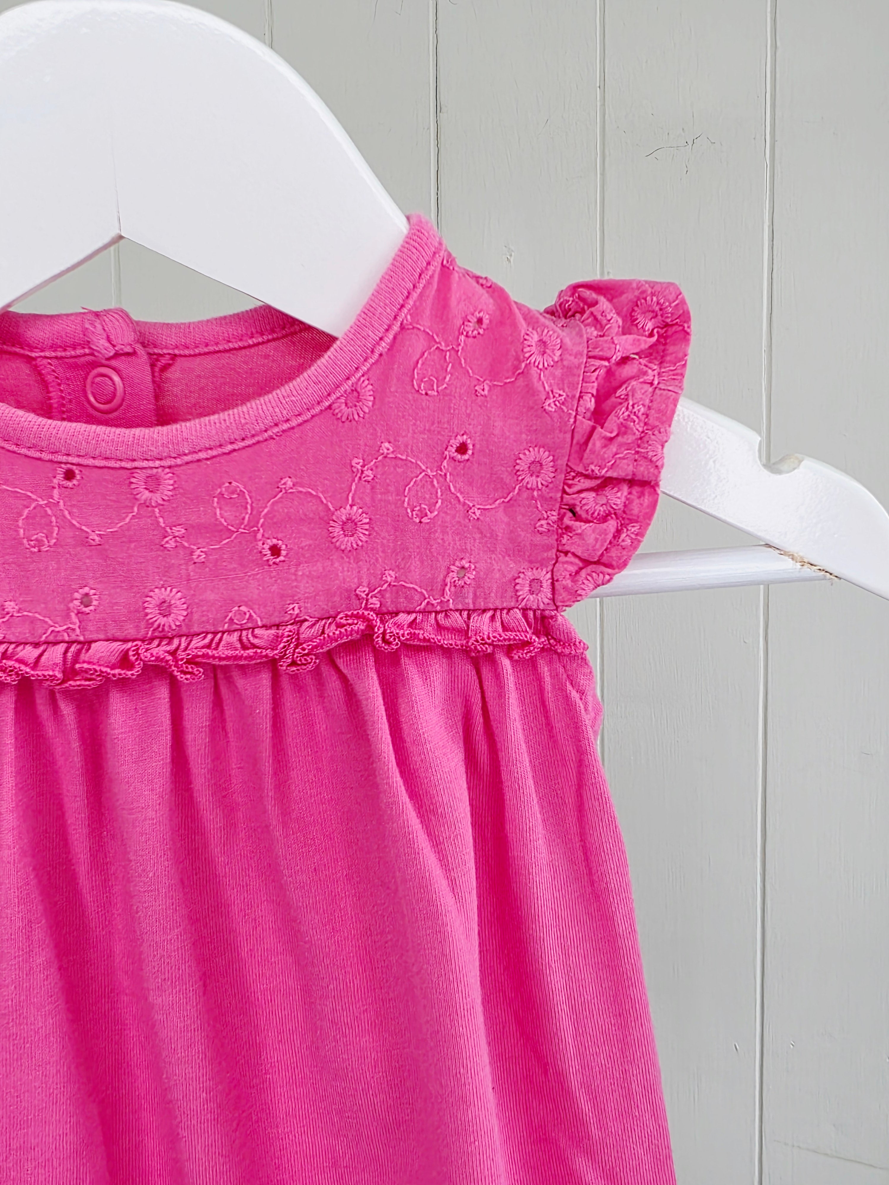 Nutmeg - newborn girls romper featuring broiderie anglaise detailing