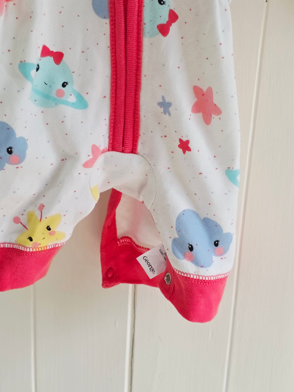 George - First size "Cosmo" hooded baby girl romper featuring a vibrant space-themed print and pink trim