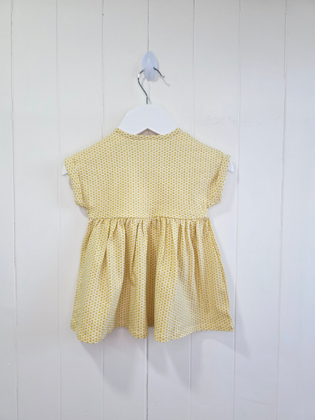 Next - up to 3 months baby dress features a mustard yellow geometric print