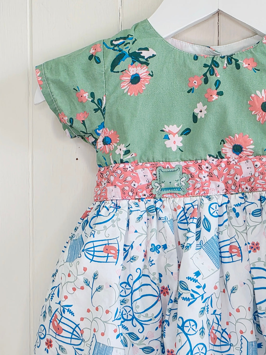 The essential one - 3-6 months green floral bodice and a white skirt printed with blue outlines of cages and flowers dress