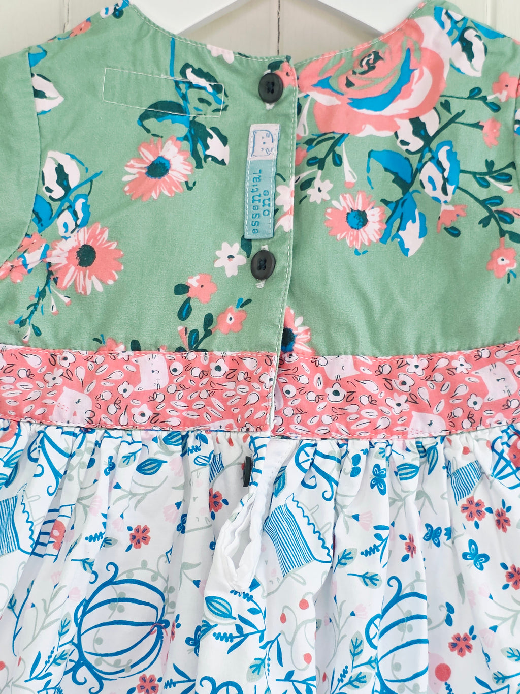 The essential one - 3-6 months green floral bodice and a white skirt printed with blue outlines of cages and flowers dress