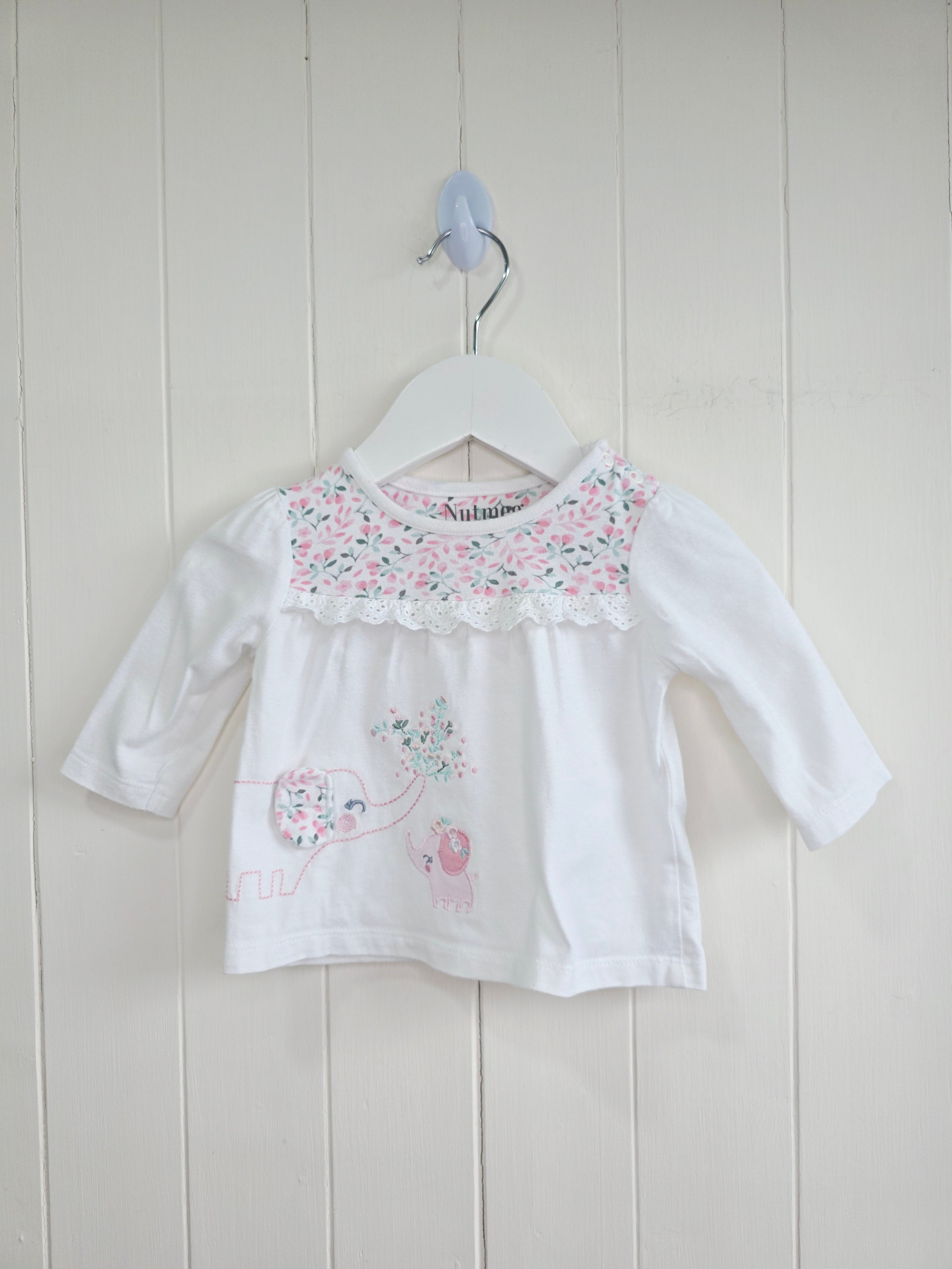 Nutmeg -0-3 months girls white long sleeve top featuring floral yoke and elephant applique