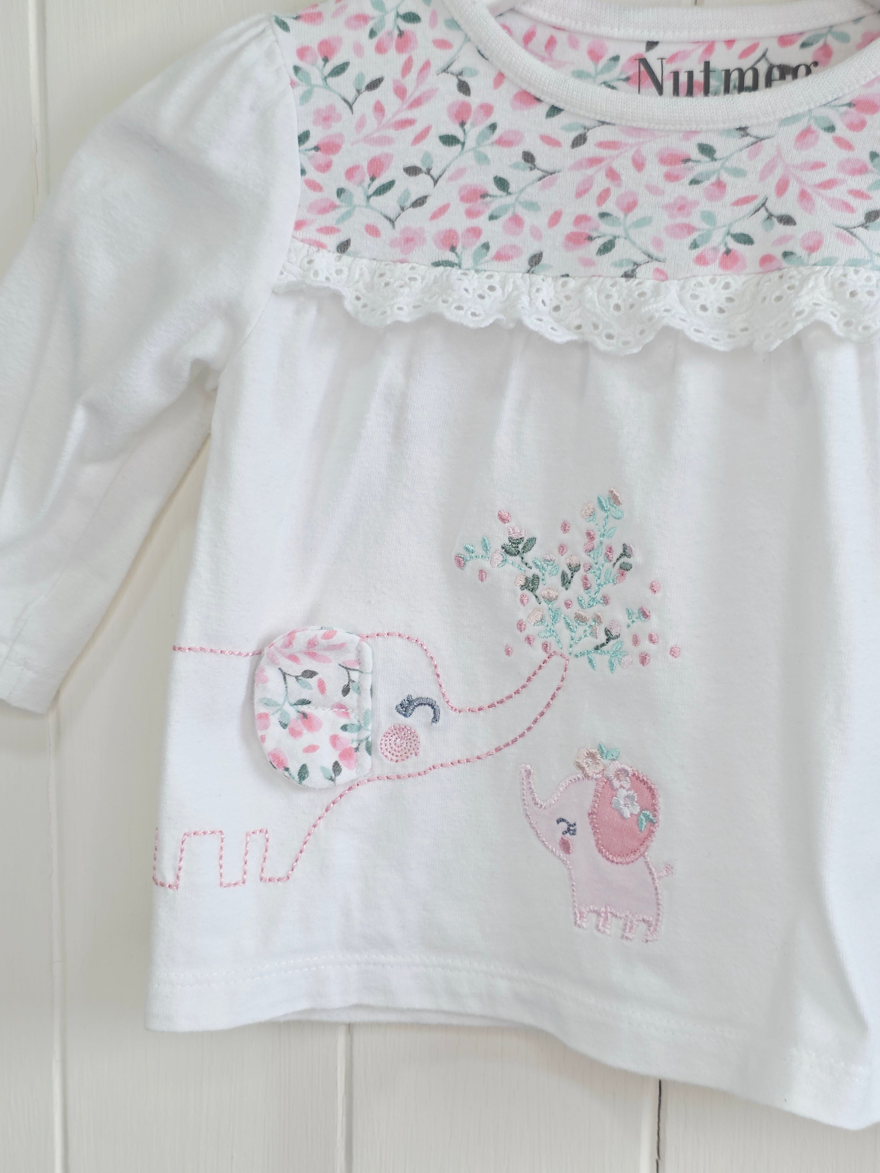 Nutmeg -0-3 months girls white long sleeve top featuring floral yoke and elephant applique