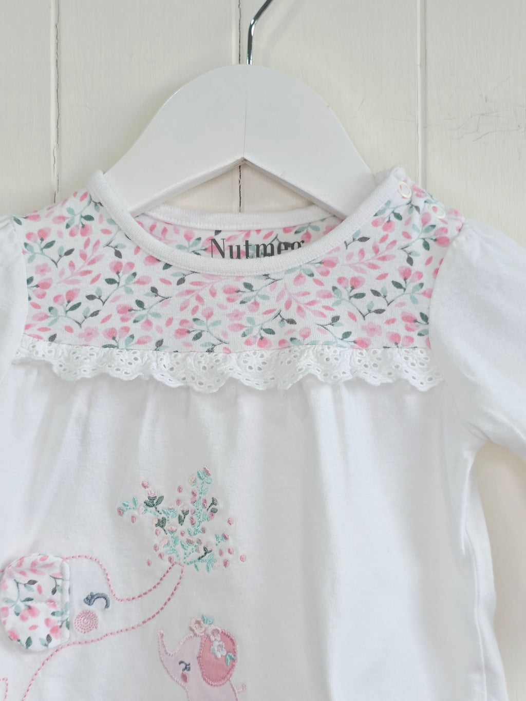 Nutmeg -0-3 months girls white long sleeve top featuring floral yoke and elephant applique