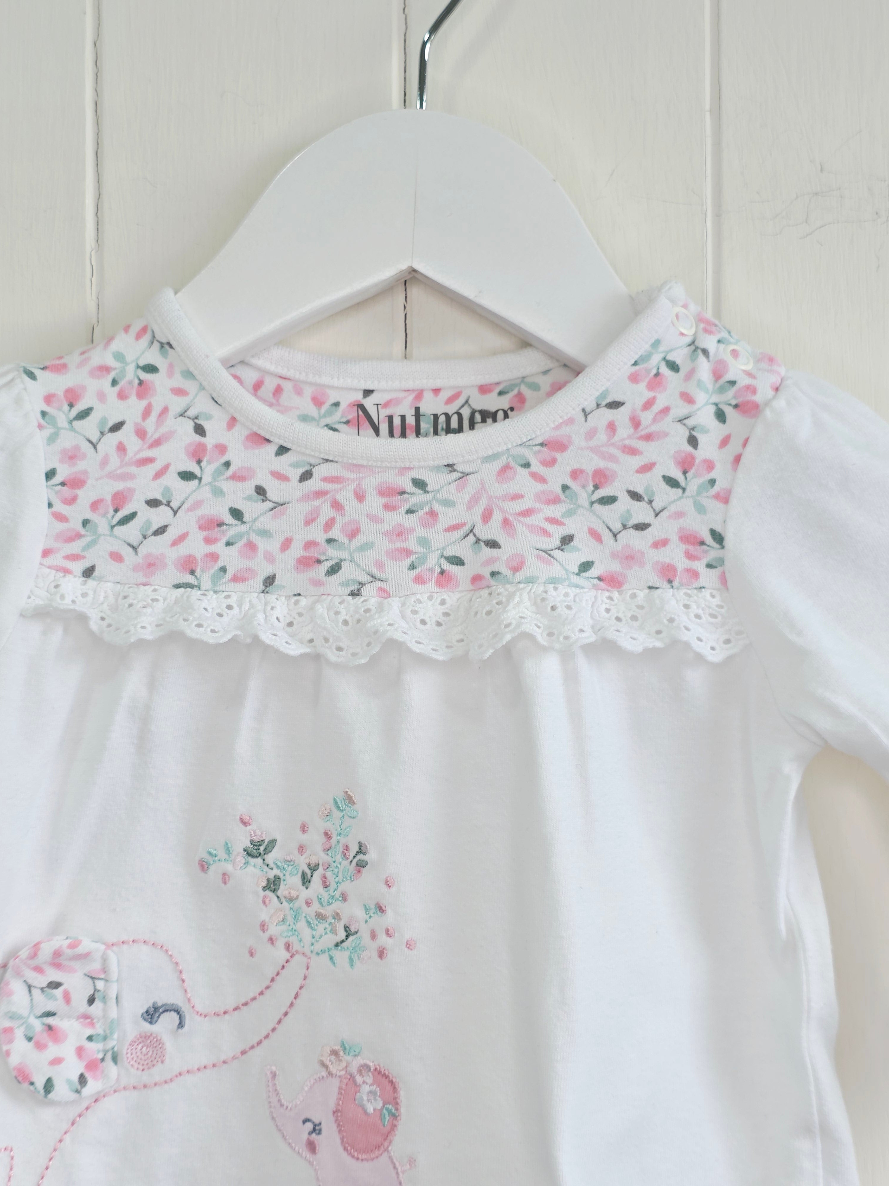 Nutmeg -0-3 months girls white long sleeve top featuring floral yoke and elephant applique