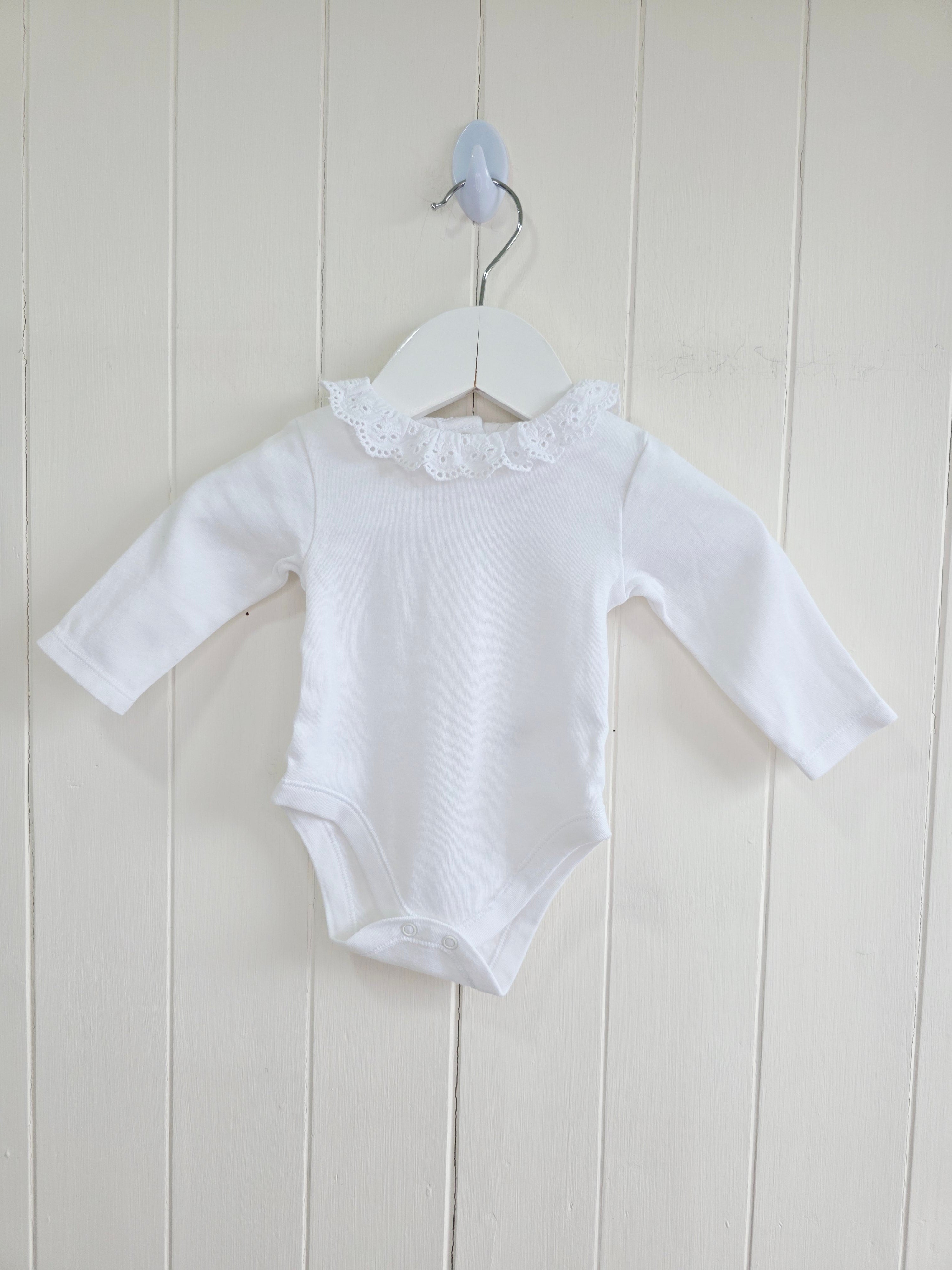 Nutmeg - 0-3 months girls bodysuit features a delicate white embroidered frill collar and long sleeves