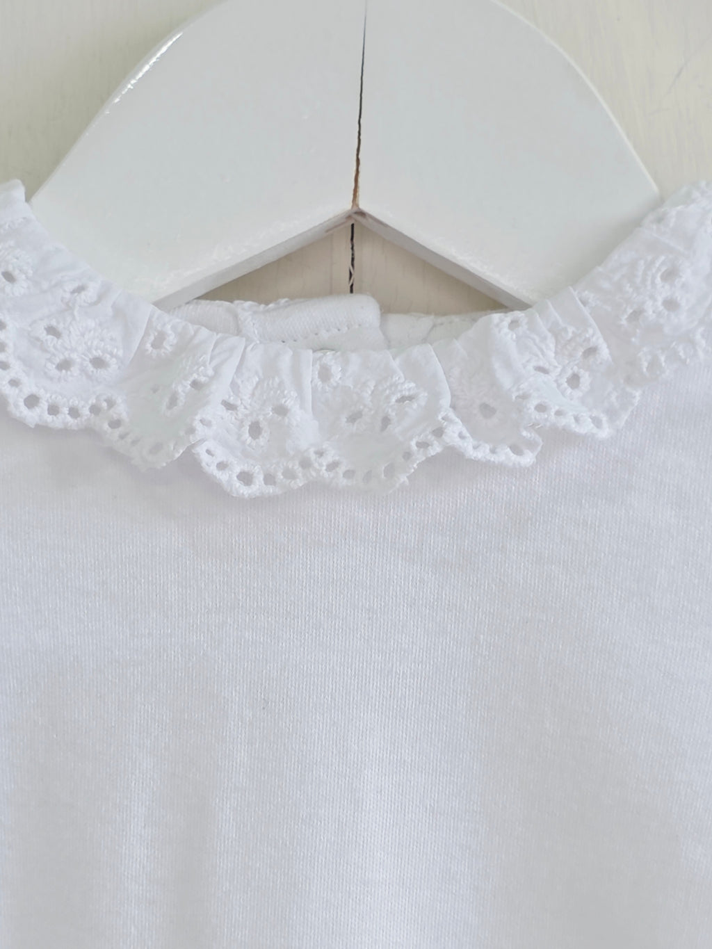 Nutmeg - 0-3 months girls bodysuit features a delicate white embroidered frill collar and long sleeves