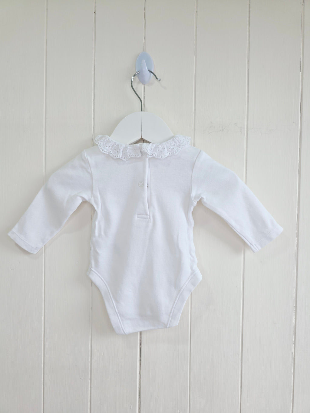 Nutmeg - 0-3 months girls bodysuit features a delicate white embroidered frill collar and long sleeves