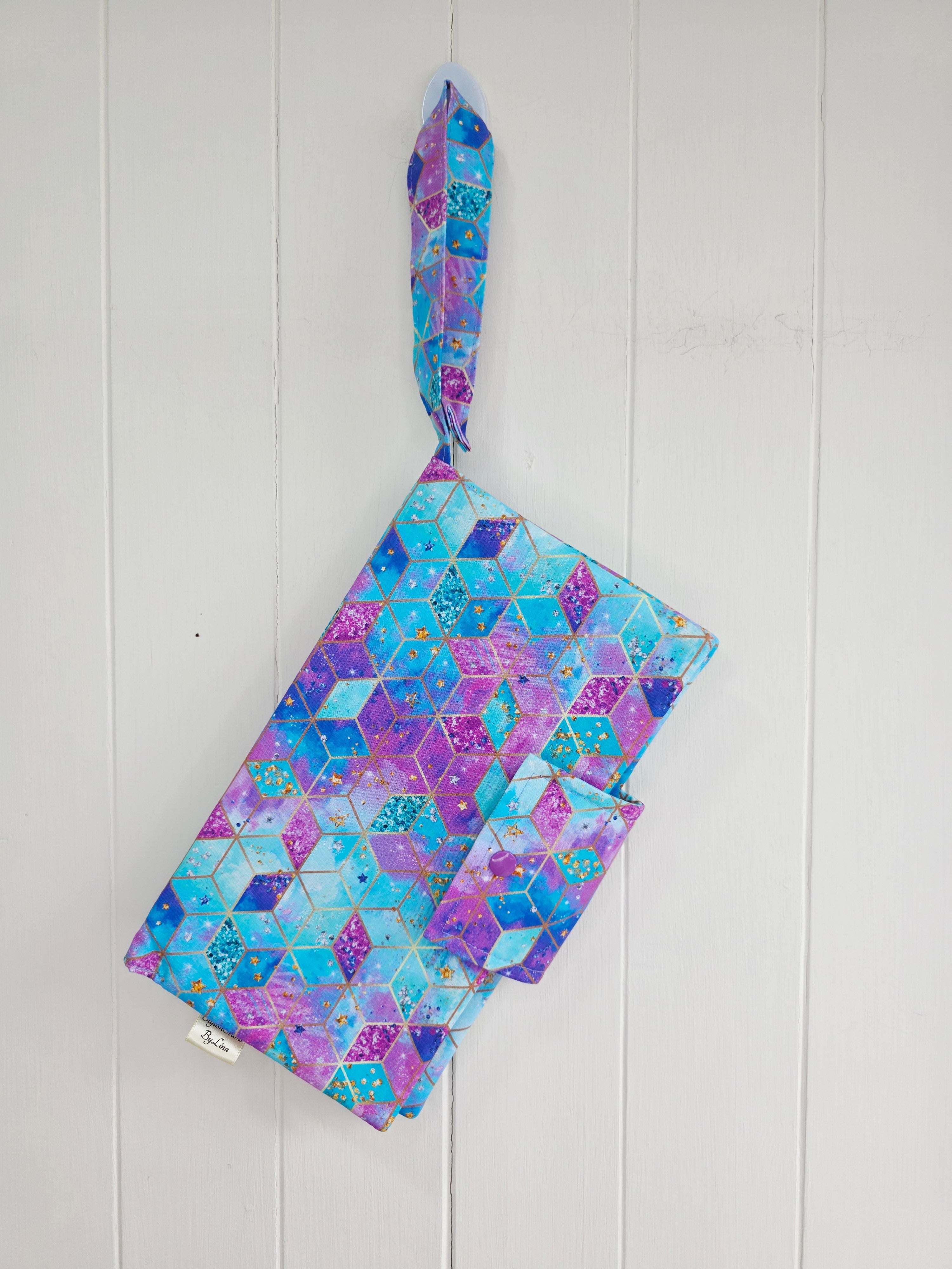 Handmade - mini nappies and wet wipes wallet featuring colorful geometric "Cosmic Squares" design in shades of aqua and violet