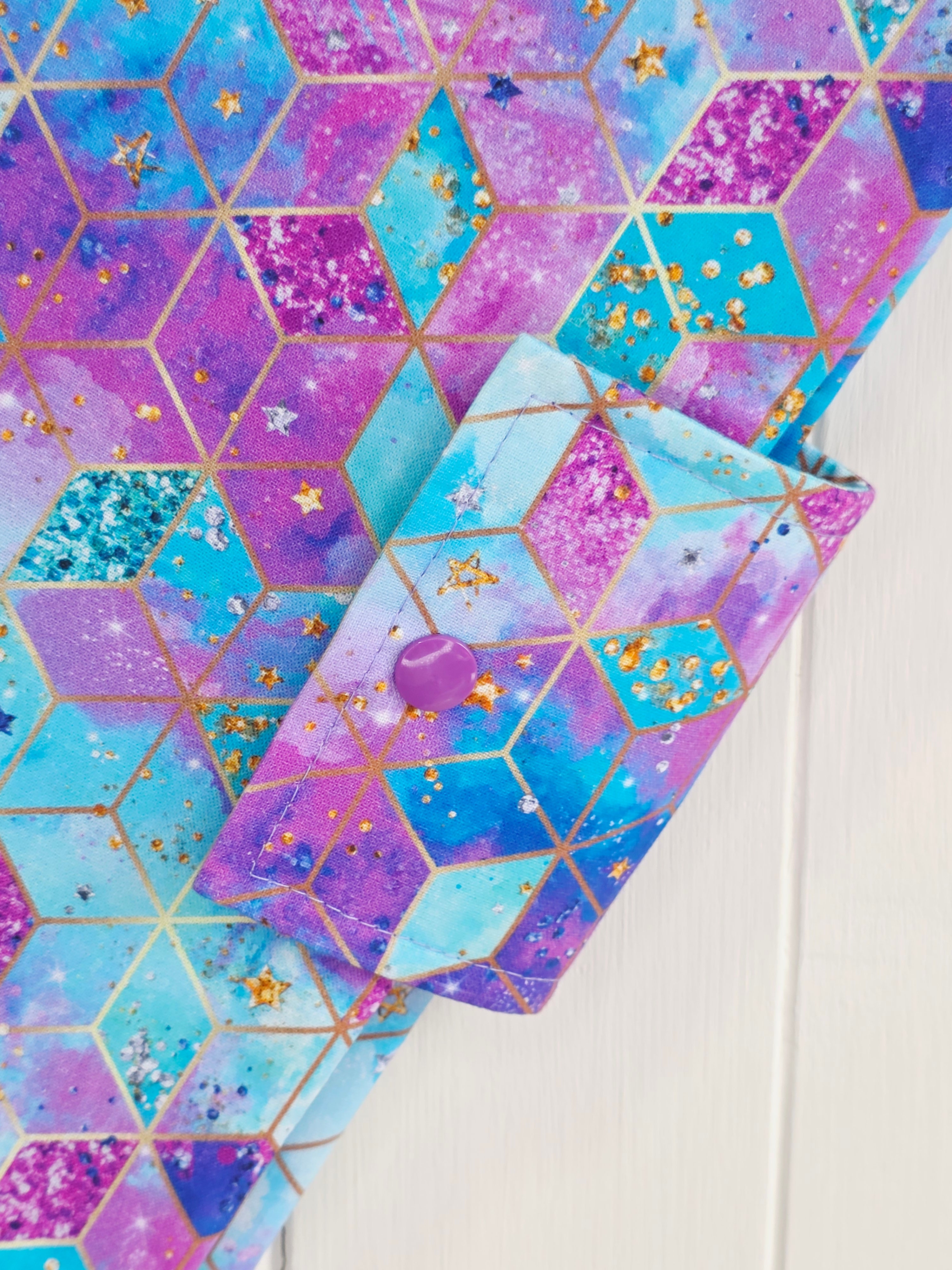 Handmade - mini nappies and wet wipes wallet featuring colorful geometric "Cosmic Squares" design in shades of aqua and violet
