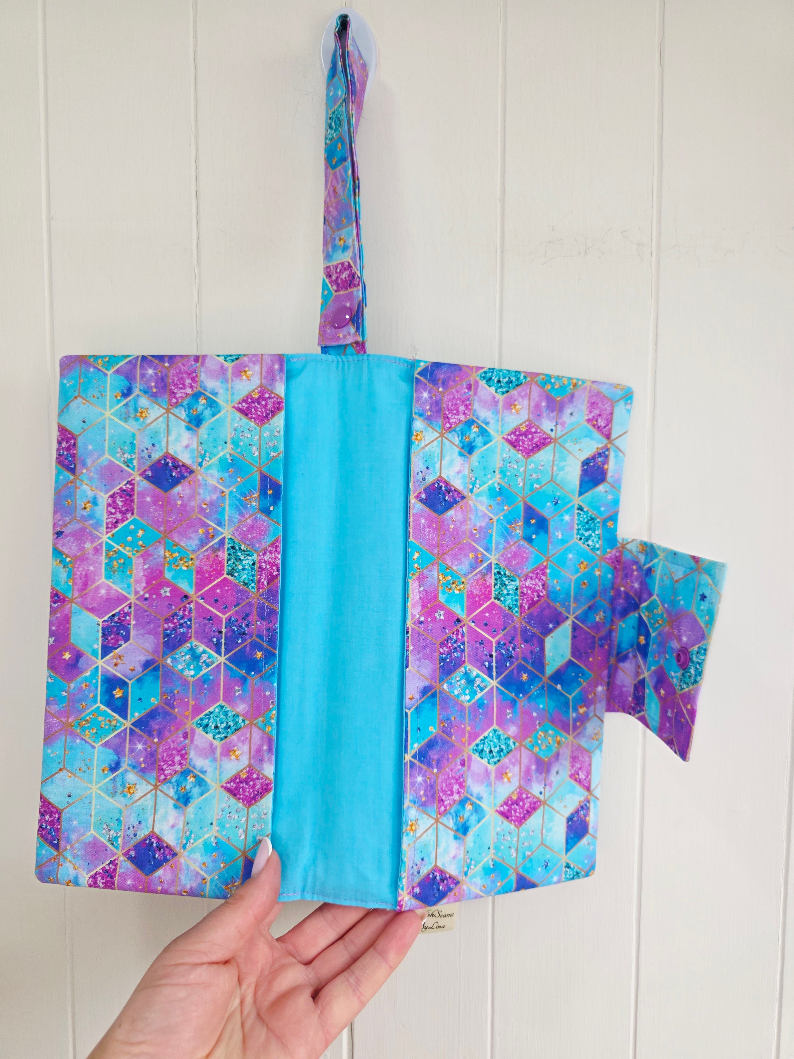 Handmade - mini nappies and wet wipes wallet featuring colorful geometric "Cosmic Squares" design in shades of aqua and violet