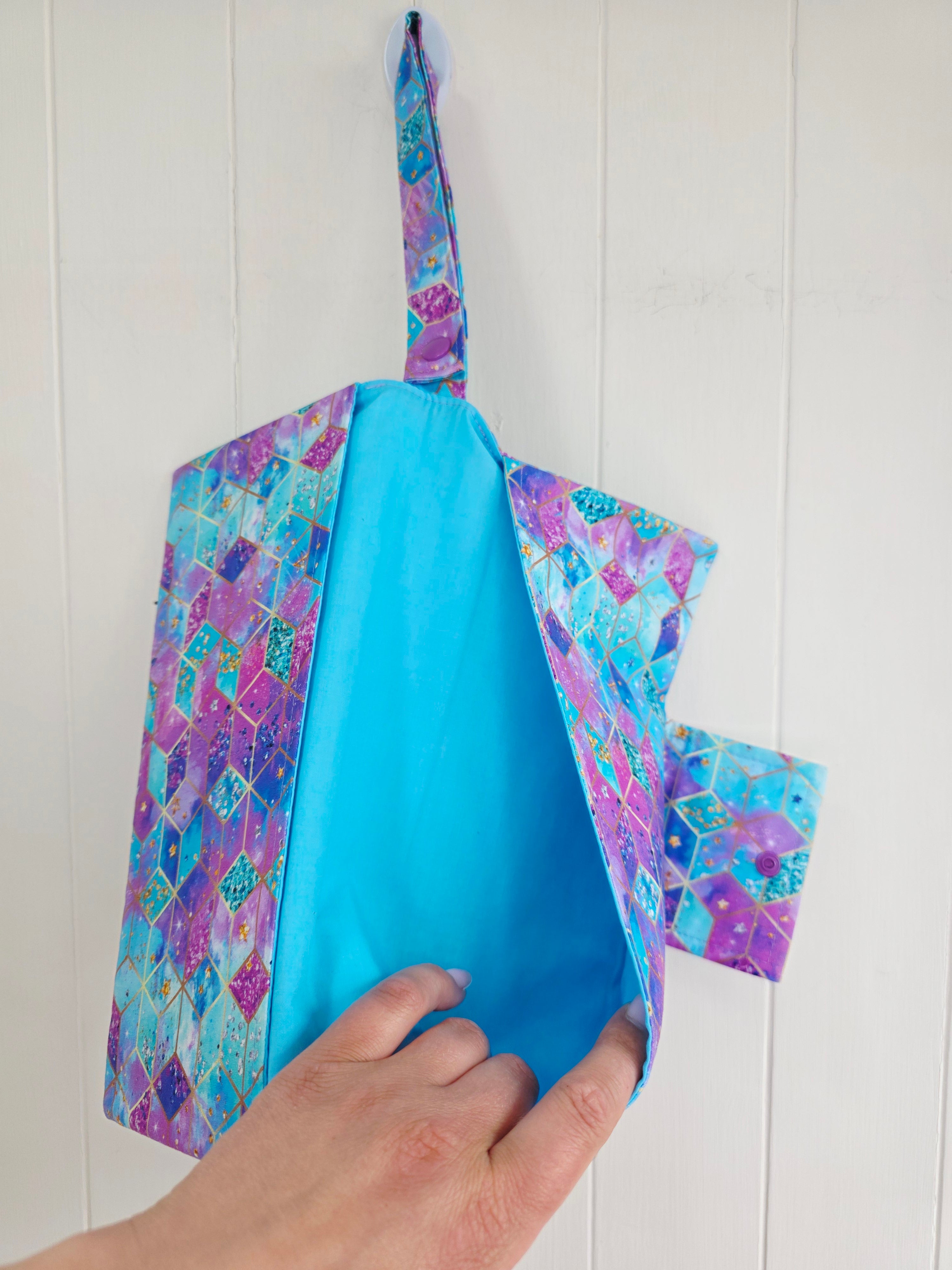 Handmade - mini nappies and wet wipes wallet featuring colorful geometric "Cosmic Squares" design in shades of aqua and violet