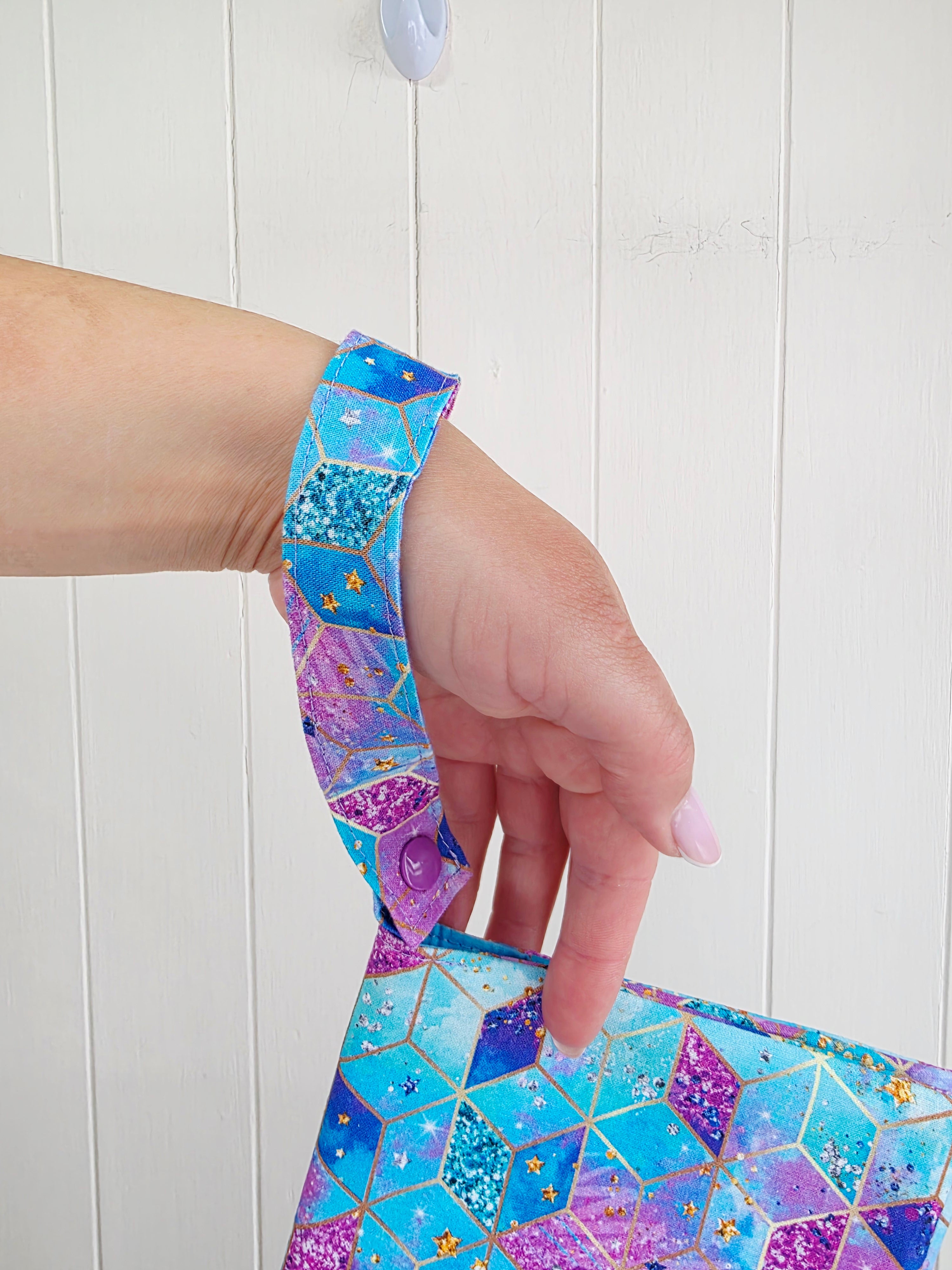 Handmade - mini nappies and wet wipes wallet featuring colorful geometric "Cosmic Squares" design in shades of aqua and violet