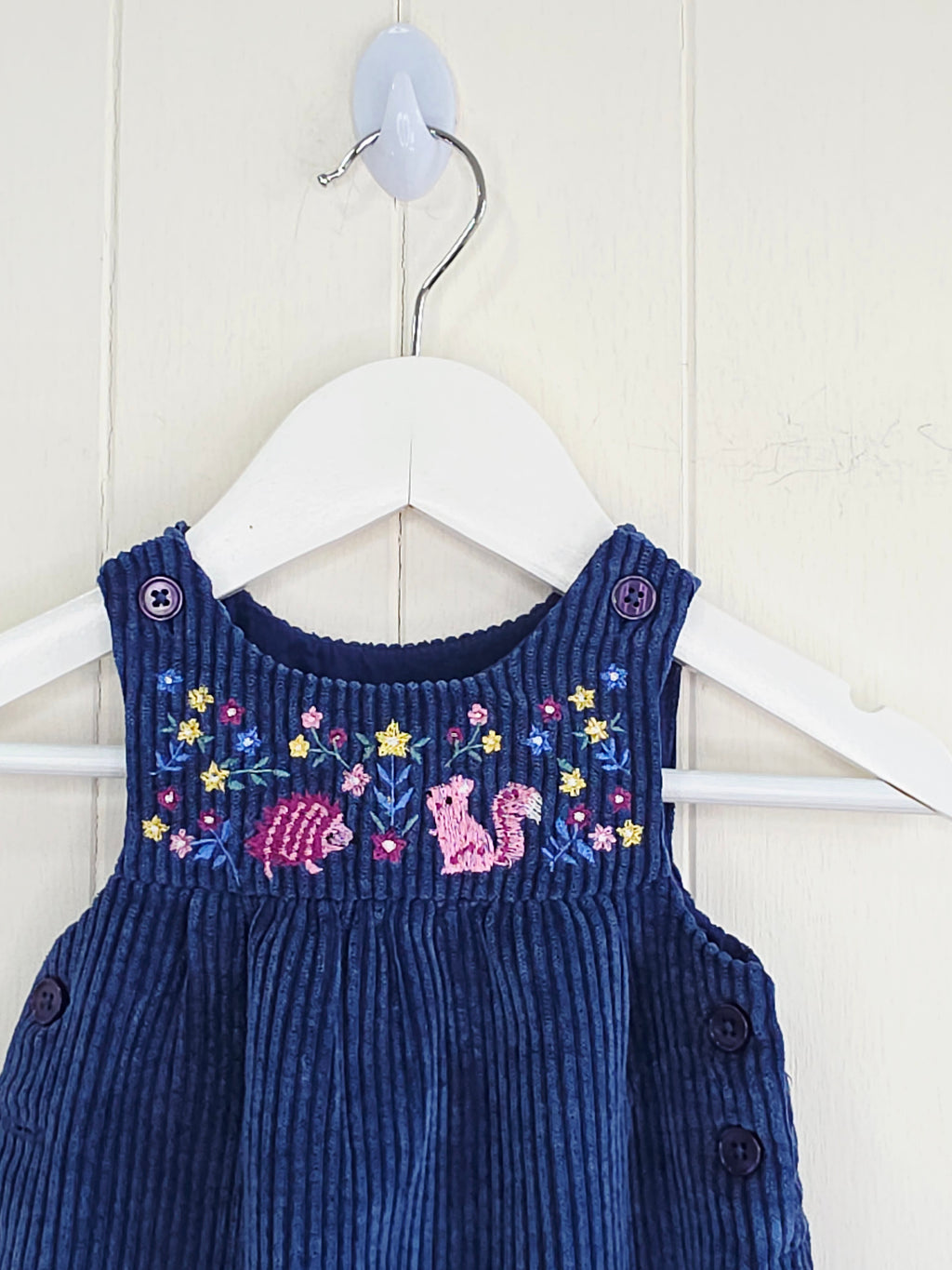 Nutmeg - 3-6 months navy blue corduroy romper features colorful embroidered animal and flower details on the chest