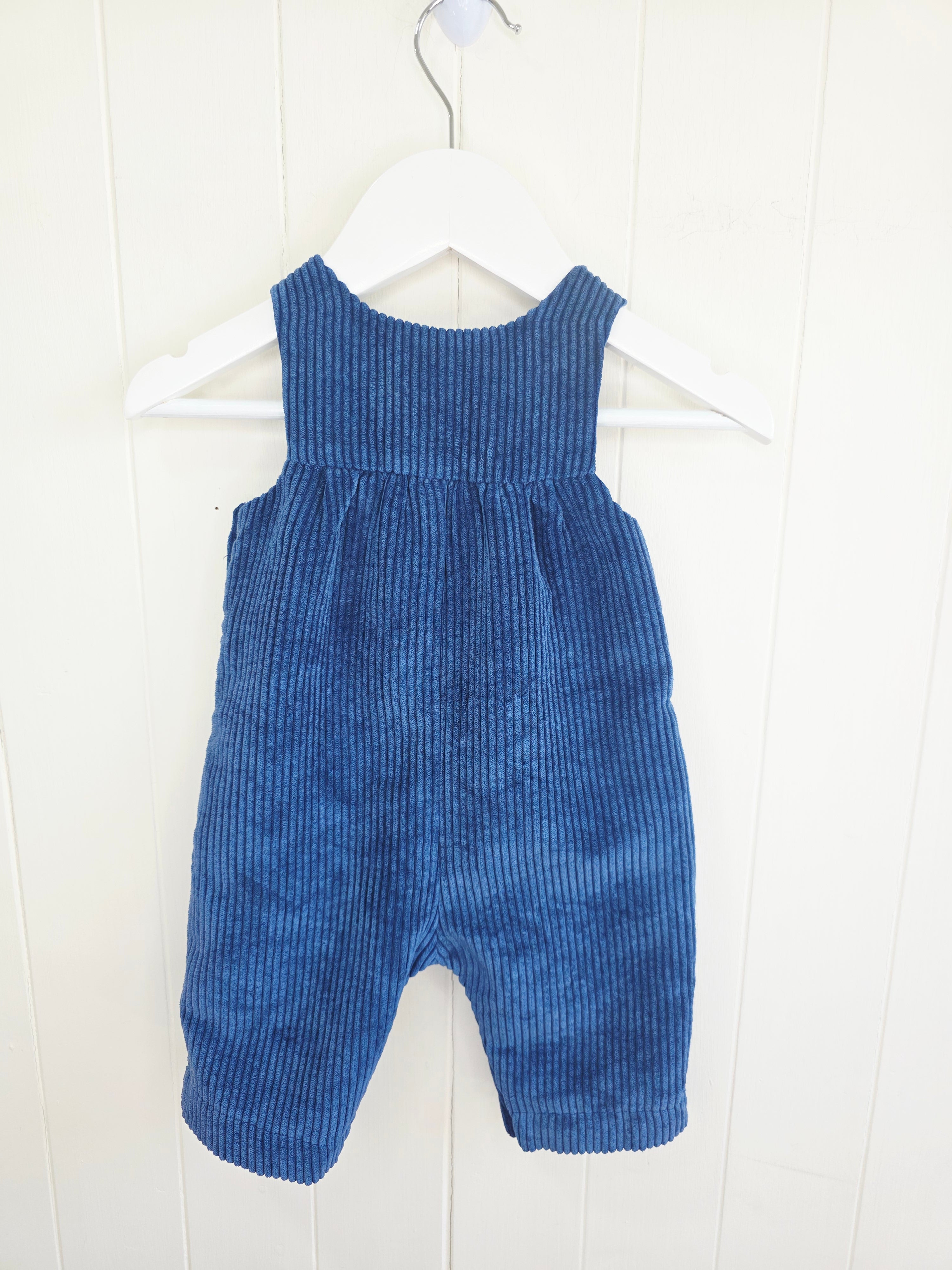 Nutmeg - 3-6 months navy blue corduroy romper features colorful embroidered animal and flower details on the chest