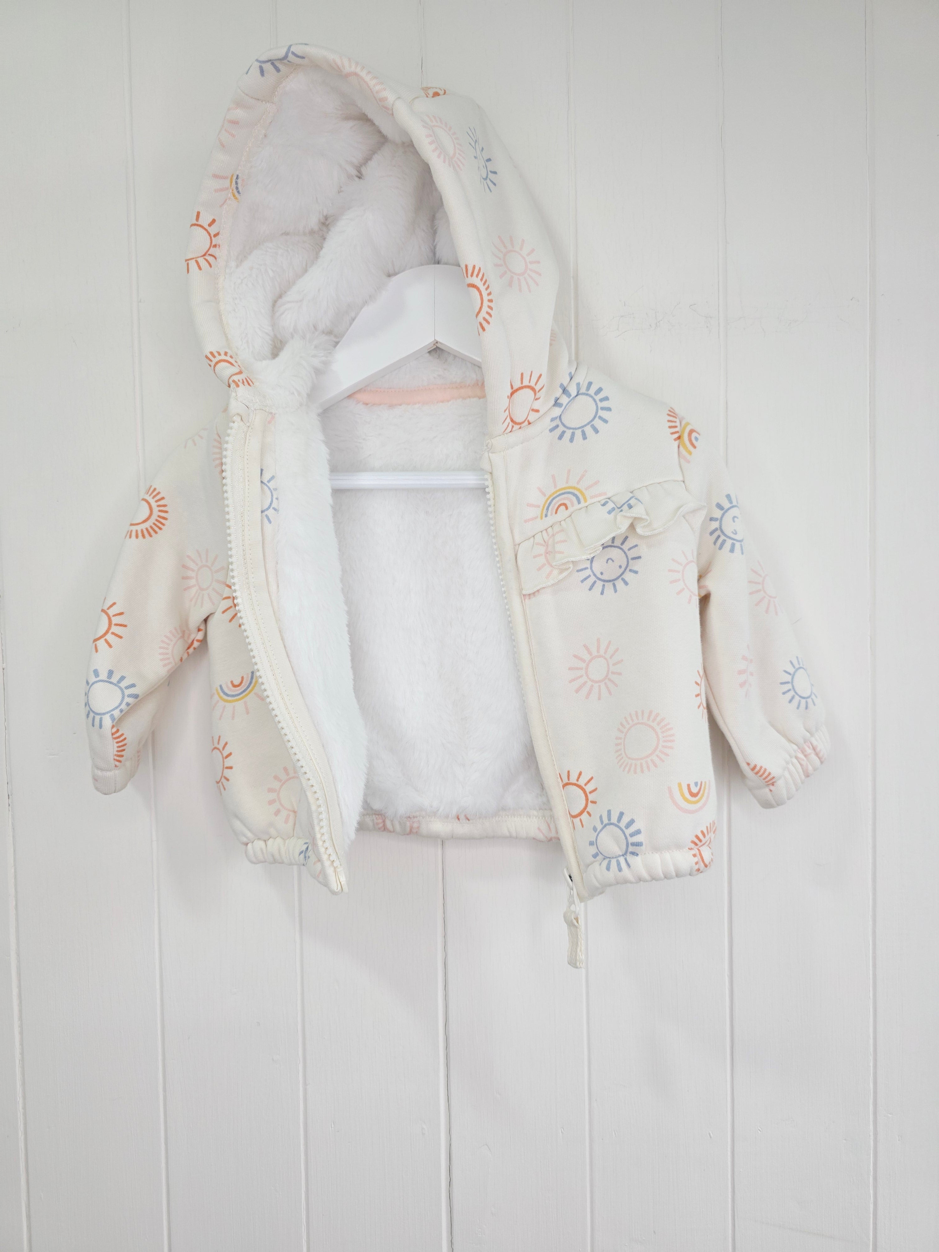 Nutmeg - 3-6 months girls cream hooded jacket featuring faux fur lining and rainbow print
