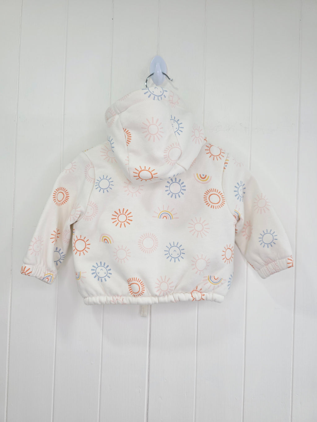 Nutmeg - 3-6 months girls cream hooded jacket featuring faux fur lining and rainbow print