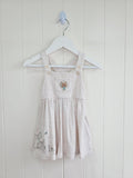 3-3 months pinafore dress features an embroidered "We're Going on a Bear Hunt" design and charming button details
