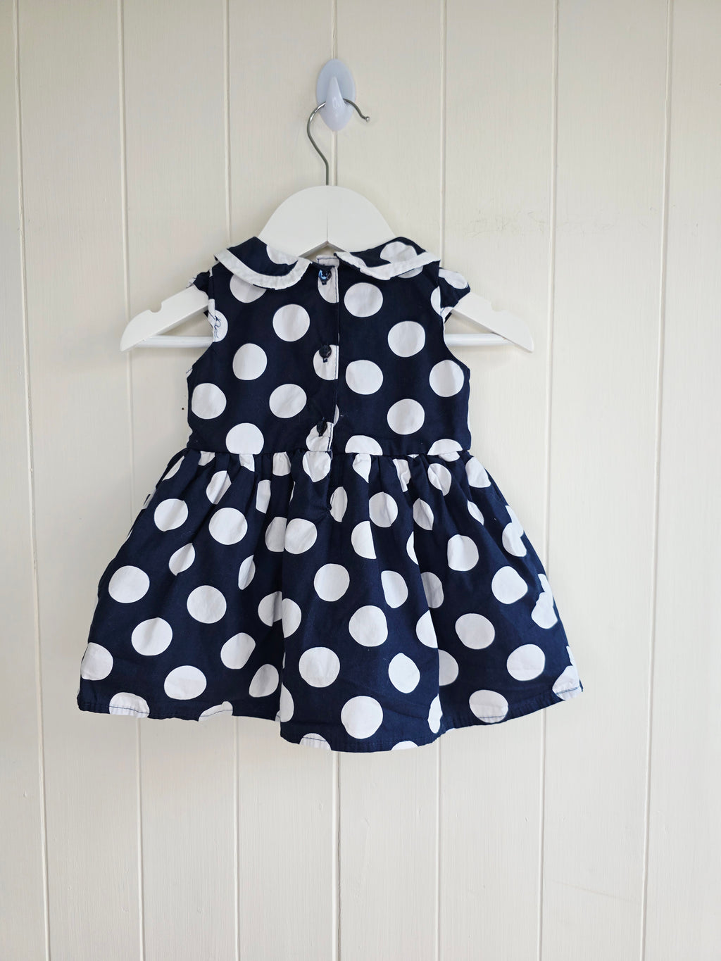 Early days - 3-6 months girls navy blue sleeveless dress featuring giant polka dots and Peter Pan collar