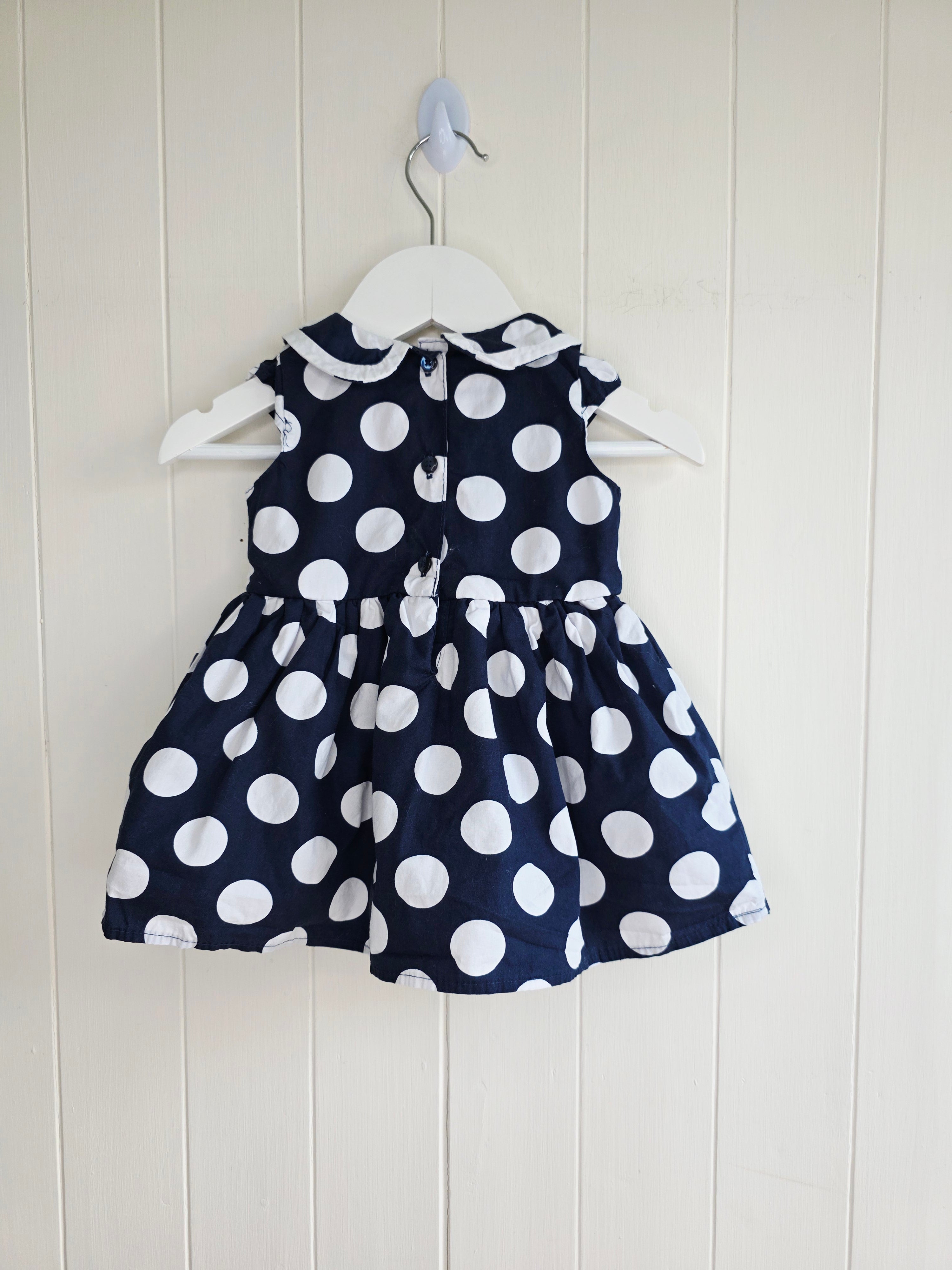 Early days - 3-6 months girls navy blue sleeveless dress featuring giant polka dots and Peter Pan collar